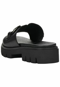 Black leather slide sandal with a wide upper strap and chunky, textured sole. Features a glossy accent on the strap and a flat footbed.