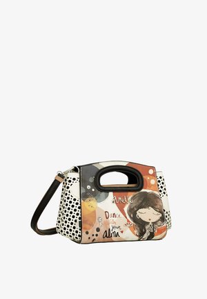 Sac à main coloré avec une illustration ludique d'un côté, un motif à pois de l'autre, et une poignée solide. Matériau : synthétique.