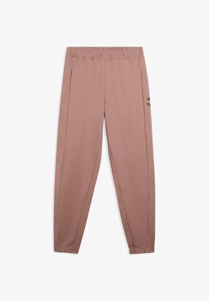 Pantalones de chándal rosa claro con cintura elástica, bolsillos laterales y detalle en texto negro en el muslo izquierdo. Tejido suave con piernas ajustadas.