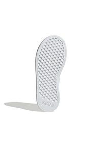 White rubber shoe sole with a textured honeycomb pattern and embossed logo. Rounded toe and slightly raised edge. Smooth finish.