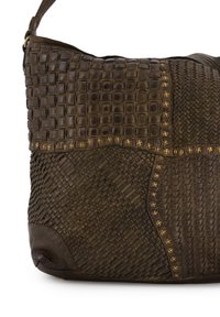 Brown leather handbag with woven texture, geometric patterns, and gold stud accents. Curved shape with adjustable shoulder strap.