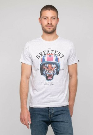 T-shirt en coton gris avec un graphique de tigre portant un casque, accompagné du texte "LE PLUS GRAND" et "La Moto la Plus Chaude" en dessous.