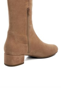 Tan suede ankle boot with a low block heel, side zipper, and smooth texture. Rounded toe and minimalist design.