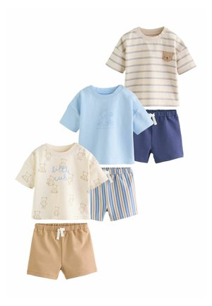 Three sets of toddler clothes with short-sleeve tops and shorts; designs include teddy bears, stripes, and solid colors in beige, blue, and cream.
