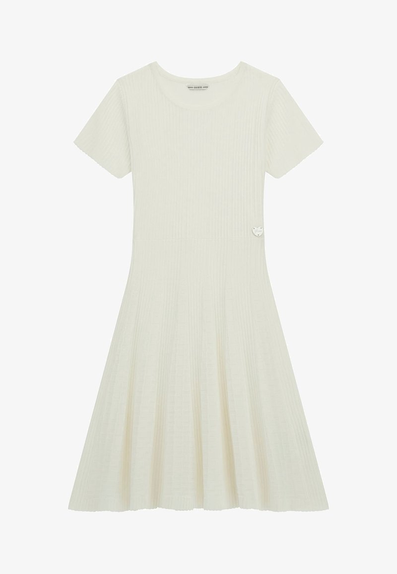 Abito crema con coste, maniche corte, gonna svasata e tessuto texturizzato. Presenta un piccolo dettaglio a forma di cuore argentato vicino alla vita.