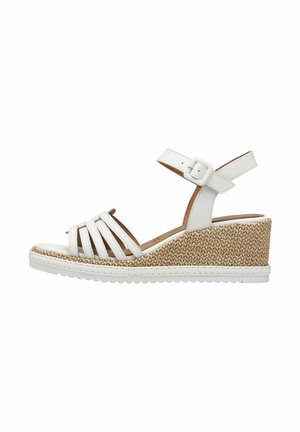 Sandale compensée blanche avec texture en jute tressé, bride de cheville réglable et design ouvert à l'avant. Présente plusieurs fines lanières avant pour un soutien optimal.