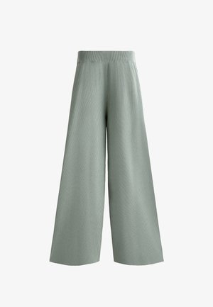 Halványzöld, bő szárú nadrág bordás textúrával. Rugalmas derékrésszel és laza sz Siluette-tel rendelkezik. Nincsenek látható záródások vagy zsebek.