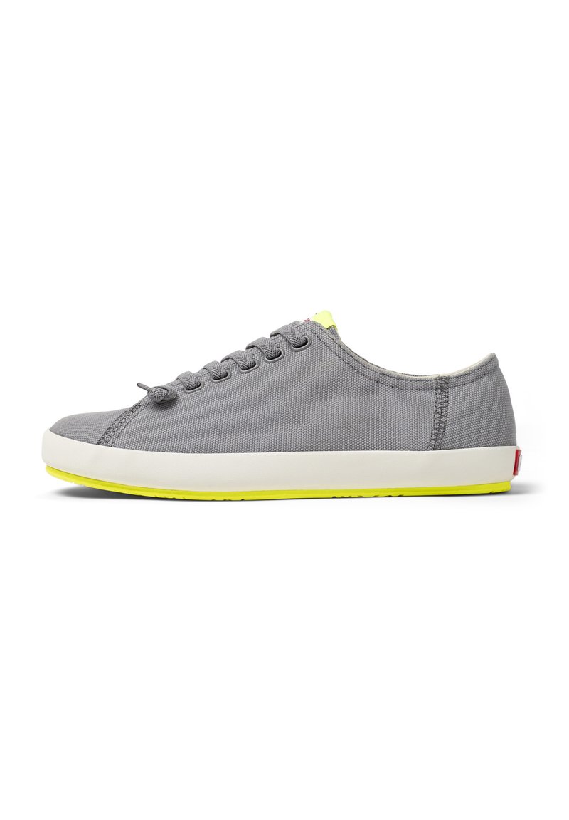 Gray canvas sneaker with a round toe, five eyelets, and bright yellow sole accent. Smooth texture with contrasting stitching.