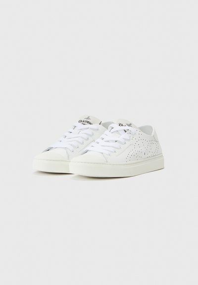 White sneakers made of smooth leather and canvas, featuring perforated designs, flat laces, and a rubber sole. Minimal branding on tags.