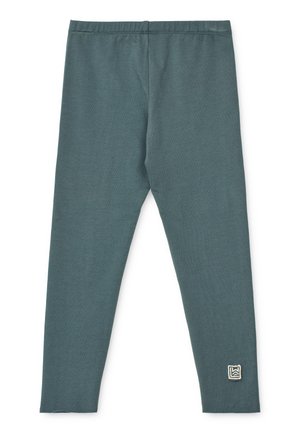 Leggings teal fabriqués en tissu léger et extensible. Ils possèdent une taille sécurisée et un petit logo brodé en bas à gauche.