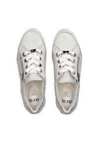 White sneakers with a glossy finish, featuring silver accents, lace-up design, and a side zipper. Interior labeled "High Soft."