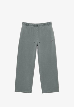 Pantaloni jogger dalla vestibilità comoda in cotone grigio tenue, con vita elastica e cordino, tasche laterali e un semplice dettaglio del logo.