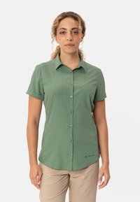Green short-sleeve button-up shirt featuring a checkered pattern, lightweight fabric, and a subtle brand logo at the hem.