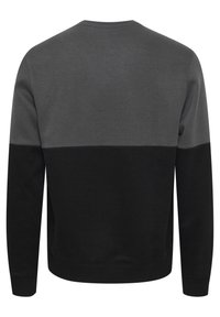 Sweater met een color-block ontwerp met delen in donkergrijs, lichtgrijs en zwart. Gemaakt van zacht materiaal met een ronde hals en geribde manchetten.