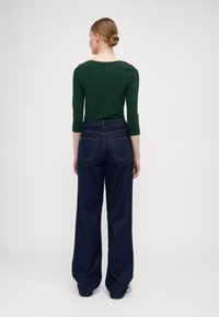ONLY Tall ONLJUICY WIDE RINSE  - Wide leg - dark blue denim