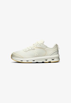 Sneakers in off-white mesh and leather, with a textured upper, round toe, and a cushioned sole featuring yellow accents on the outsole.