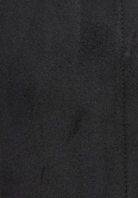 Black suede fabric with a soft, textured surface. Features a consistent color with a subtle sheen and smooth stitching detail.