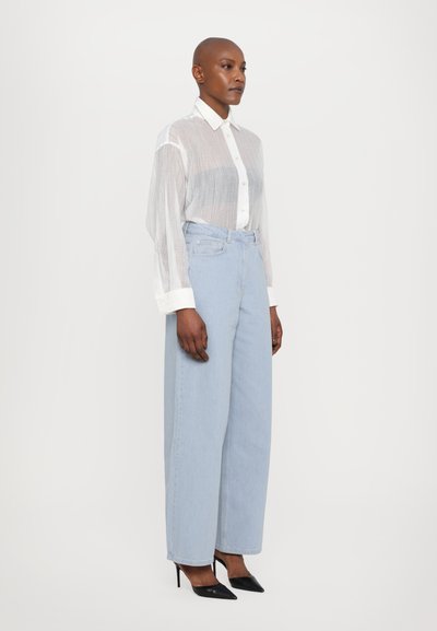 REMAIN COCOON PANTS - Široke nogavice - light blue