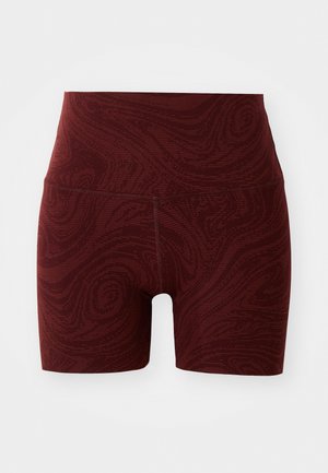 Red patterned shorts with a high waistband, featuring a textured design. Made from stretchy material, ideal for activewear.