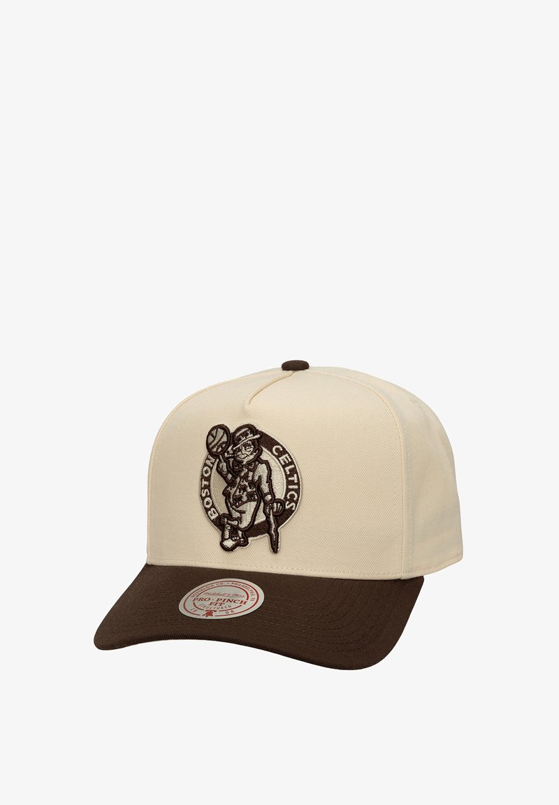 Beige cap with a dark brown brim, featuring a vintage Boston Celtics logo in brown embroidery on the front. Classic design with a rounded crown.