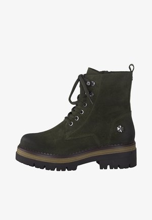 Green suede lace-up boot with a round toe, thick black rubber sole, and silver flower accent on the side. Classic design, well-constructed.