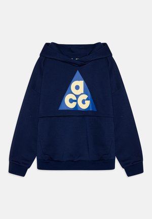 Sweatshirt à capuche bleu marine avec un design graphique triangulaire affichant "ACG" en crème. Texture douce, poignets et ourlet élastiques.