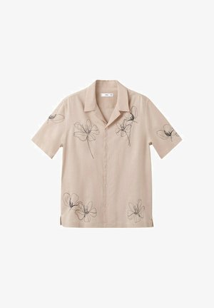 Chemise beige à manches courtes avec boutons, motifs floraux noirs minimalistes en lignes sur le devant, les manches et l'ourlet inférieur.
