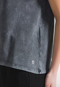 Grijze T-shirt met korte mouwen van zachte, gestructureerde stof met een subtiel waseffect. Voorzien van een logolabel aan de onderzijde en nette stiksels.