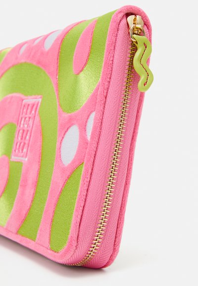 Zippered pouch featuring a vibrant pink and green design with smooth and textured surfaces, gold hardware, and circular accents.
