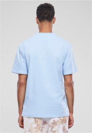 Light blue cotton t-shirt with short sleeves and a classic crew neck. Smooth texture with a relaxed fit. No visible logos or patterns.