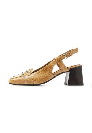 Tan leather slingback shoe with chunky dark brown block heel and silver studs on the toe area.