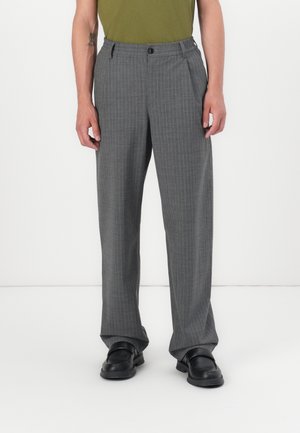 Gray striped trousers with a relaxed fit, featuring a button closure, elastic waistband, and smooth texture. Paired with black shoes.