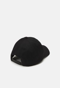 Black baseball cap with a curved brim, fabric texture, adjustable strap at the back, and stitched ventilation holes on the sides.