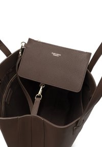 Brown leather tote bag featuring a textured finish, with a matching pouch inside, secured by a gold zipper, and a logo on the pouch.
