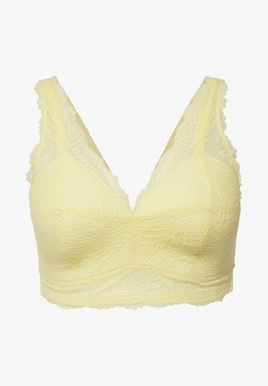Brassière en dentelle jaune avec un motif en vagues texturé, dotée de larges bretelles et d'un décolleté en V, conçue pour un ajustement sans couture.