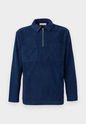 Ναυτικό μπλε πουλόβερ από κορδούρα με μακριά μανίκια, κοντό φερμουάρ στο μπροστινό μέρος, δύο τσέπες στο στήθος και γιακά ανοιχτού τύπου.