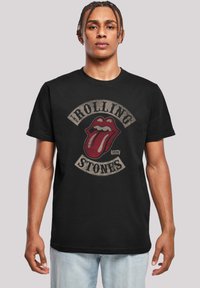 Zwarte katoen T-shirt met een groot rood Rolling Stones-logo met een tongafbeelding, vintage-stijl lettering en een ronde hals.