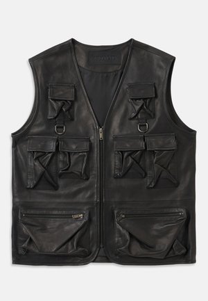 Black leather vest with multiple flap and zippered pockets, front zipper closure, and D-ring details on upper chest.