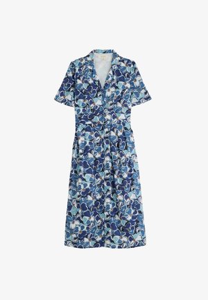 Kukkaistoukka, jossa on lyhyet hihat, esittelee sinisiä ja vaaleansinisiä kukkia tummansinisellä taustalla. Napillinen etusivun ja vyötärön yksityiskohta.