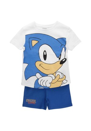 Maglia bianca a maniche corte con grande grafica del volto di Sonic the Hedgehog e pantaloncini blu con la scritta "Sonic Hedgehog" sulla gamba sinistra.