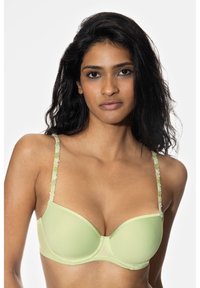 Vaaleanvihreä rintaliivi, jossa on pehmustetut kupit ja kukkakuvioinen pitsiyksityiskohta säädettävissä olkaimissa. Sileä pinta ja saumaton muotoilu.