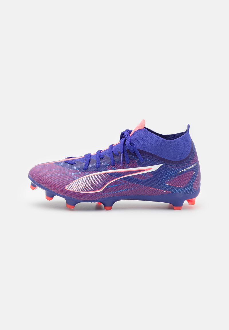 Purple soccer cleat with a woven texture, contrasting pink accents, and a low-cut design. Features a white logo and orange studs.
