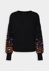 Sweat-shirt noir à manches longues avec broderie florale colorée sur les manches, présentant des fleurs et des feuilles orange, violettes, roses et jaunes.