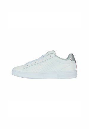 White leather sneakers with a smooth texture, featuring a light gray heel accent, flat laces, and a white rubber sole. Side stitching visible.