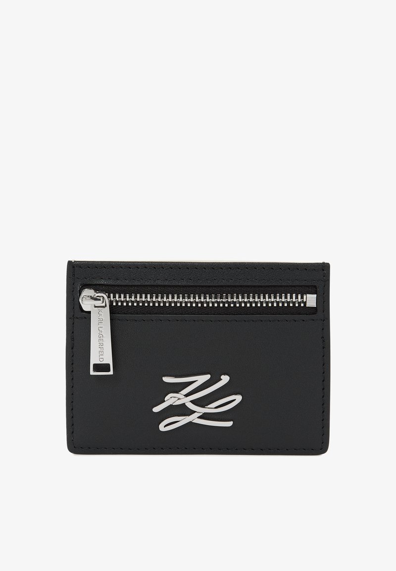 Μαύρη δερμάτινη θήκη καρτών με ασημένιο φερμουάρ στην κορυφή και ασημένιο λογότυπο KL στο μπροστινό μέρος.