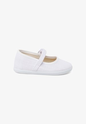 Chaussure Mary Jane blanche pour tout-petit, avec tige en tissu, bride ajustable et semelle souple, vue de côté sur fond blanc.