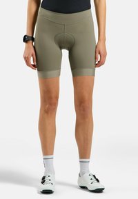 Korte fietsbroeken in olijfgroen, met een gevoerd inzetstuk, een elastische tailleband en geperforeerde accenten aan de zoom.