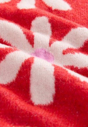 Tessuto a maglia rosso e rosa con un motivo floreale; presenta una texture morbida, petali bianchi irregolari e una forma centrale di fiore rosa.