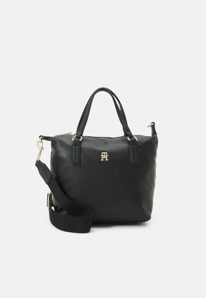 Black leather handbag with two handles, detachable wide fabric shoulder strap, and a small gold metal logo on the front.