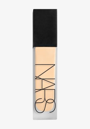 Rectangular frosted glass bottle with light beige liquid foundation and black cap, branded NARS in bold black letters.